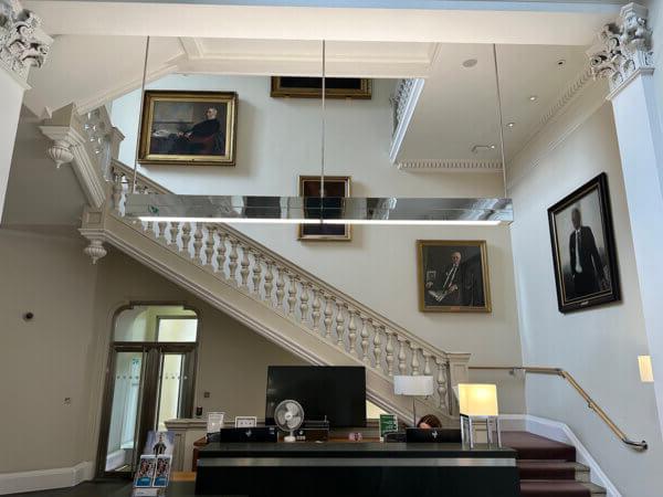 An LED pendant light fitting above a reception desk